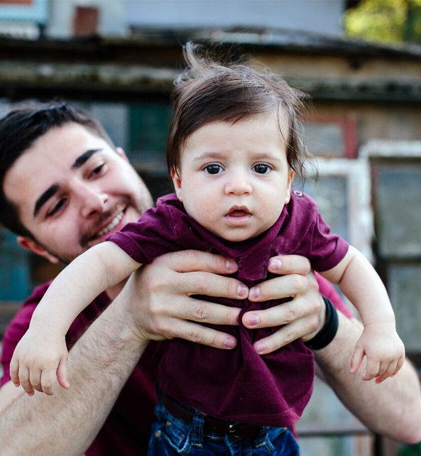 A father holding his child.